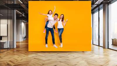 Full length body size view of three nice attractive lovely stylish cheerful cheery optimistic person having fun weekend showing v-sign isolated over bright vivid shine yellow background Wall mural