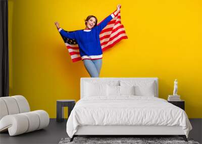 Full length photo of cheerful funky girl wear blue pullover celebrating american independence day empty space isolated yellow color background Wall mural