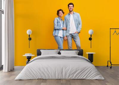 Full length photo of cheerful optimistic wife husband wear stylish denim family look isolated on yellow color background Wall mural