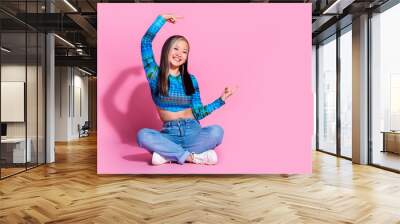 Full length photo of cheerful pretty lady dressed blue shirt showing two fingers empty space isolated pink color background Wall mural