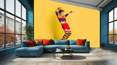 Full length photo of crazy lady youth moves dance wear striped sweater short skirt knee socks shoes isolated yellow color background Wall mural