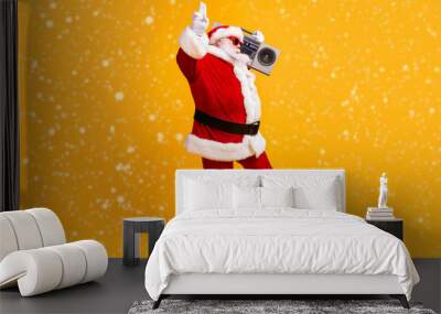 Full length photo of fat cool santa claus with beard listen boom box showing two fingers wear sunglass headwear cap isolated over bright shine color background Wall mural