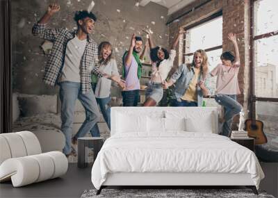 Full length photo of funky happy people dance festive event confetti fly indoors inside house apartment Wall mural