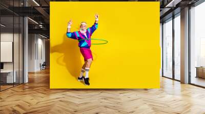 Full length photo of funny aged sportsman hula hoop empty space retro uniform isolated on yellow color background Wall mural