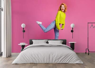 Full length photo of good mood lovely girl dressed stylish clothes isolated on bright pink color background Wall mural