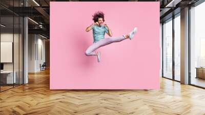 Full length photo of handsome young guy dressed casual clothes jumping fighting isolated pastel color background Wall mural