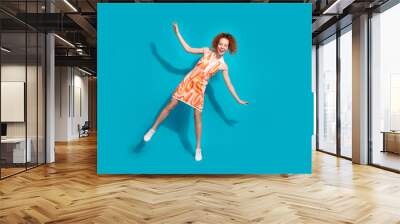 Full length photo of lovely young lady dancing have fun disco dressed stylish orange garment isolated on cyan color background Wall mural