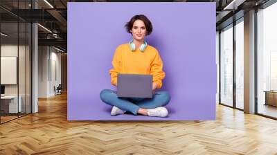 Full length photo of nice satisfied person sit use netbook write email coworking isolated on violet color background Wall mural