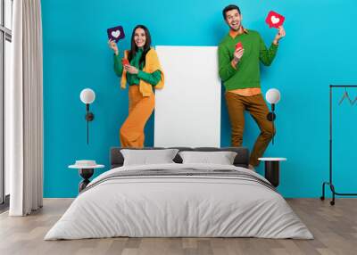 Full length photo of two people blogger board use device receive like network ecommerce post isolated on blue color background Wall mural