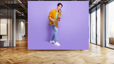 Full length photo of young man happy positive smile play sax jazz artist isolated over violet color background Wall mural