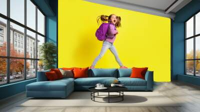 Full length profile side photo of amazed schoolkid jump go fast rush discounts isolated vivid color background Wall mural