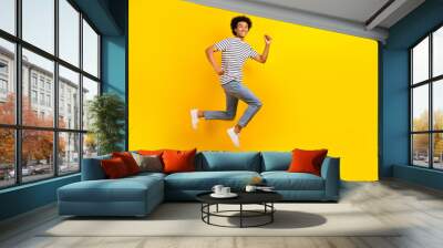 Full length size photo of running fast speed energetic guy hurry up advertisement casual clothes sale isolated on yellow color background Wall mural