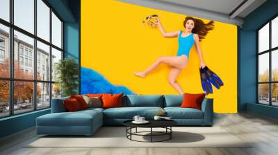 Full size high angle above flat lay view profile photo of beautiful lady seaside resort running into water hold mask flippers diver wear bodysuit isolated yellow color background Wall mural