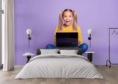 Full size photo of amazed excited child show laptop show touch screen scream wow omg sit crossed folded legs wear casual style outfit isolated over violet color background Wall mural