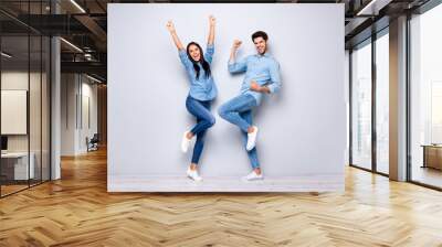 Full size photo of guy and lady celebrating successful business project raising fists air wear casual jeans clothes isolated grey color background Wall mural