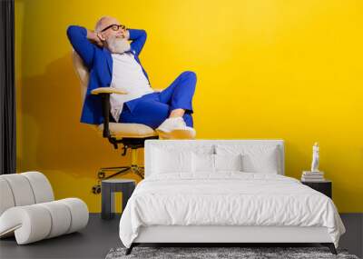 Full size photo of happy smiling businessman sit chair relaxing having break from work isolated on yellow color background Wall mural