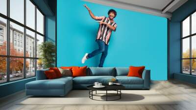 Full size photo of nice young man dancing wear shirt isolated on teal color background Wall mural