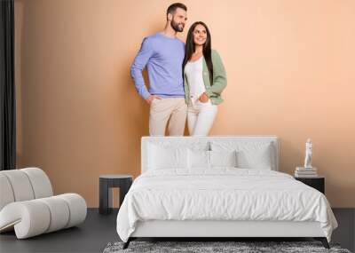 Full size photo of optimistic nice couple stand look empty space wear sweater isolated on beige color background Wall mural