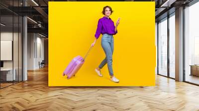 Full size photo of pretty young girl go gadget taxi application wear trendy violet smart casual outfit isolated on yellow color background Wall mural