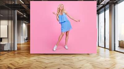 Full size photo of young cheerful woman happy positive smile dancer music look empty space isolated over pink color background Wall mural