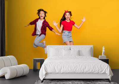 Full size portrait of two excited persons enjoy jumping open mouth isolated on yellow color background Wall mural