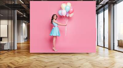 Full size profile photo of curly charming lady festive clothes event prom party carry many balloons celebrate wear blue teal mini dress skirt high-heels isolated pastel pink color background Wall mural