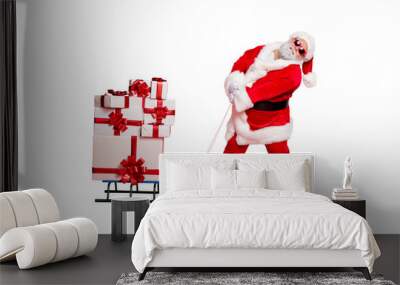 Fulll length photo of tired santa claus pulling his sledge with packages gifts on midnight wearing eyeglasses eyewear belt isolated over red background Wall mural