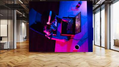 High angle view photo of young woman play gaming laptop esport neon light night apartment indoors Wall mural