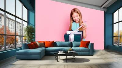 International women's day concept. Portrait of cute sweet little princess, toothy smile wearing light blue dress, she is opening present from her family isolated on bright pink background, copyspace Wall mural