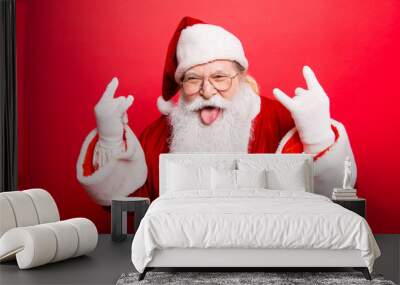 It's party time! Holly jolly swag x mas and noel!  Cool funny playful naughty grandfather with sticking tongue, comic grimace, fooling around isolated on red background, shows rock gesture Wall mural