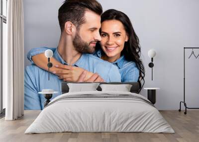 Love affair. Portrait of charming couple of millennial cheerful positive placing hands around chest wavy curly hair wearing blue denim shirts isolated on grey background  Wall mural