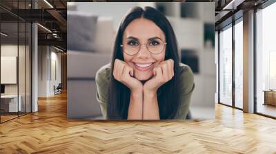 Photo of adorable positive girl arms on cheeks beaming smile look camera have good mood home indoors Wall mural