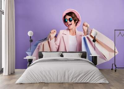 photo of amazed pretty optimistic brunette young lady do shopping wear glasses pink cap coat isolate Wall mural