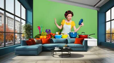 Photo of astonished girl chef gourmet prepare ecological recipe soup check boil saucepan look open cover wear yellow style stylish trendy t-shirt hair curlers isolated green color background Wall mural