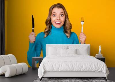 Photo of attractive charming wavy lady hold metal knife fork ready to start tasty food dinner meal good appetite wear blue turtleneck isolated bright yellow color background Wall mural