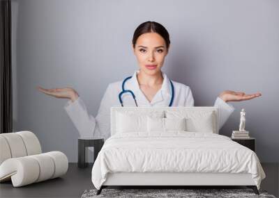 Photo of attractive doc professional hold two open palms empty space advising good quality vitamins pick select one better wear medical uniform lab coat stethoscope isolated grey background Wall mural