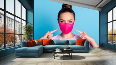 Photo of attractive lady keep social distance ignoring people contacting use respirator direct fingers safe face wear protect facial mask stylish sweater isolated blue color background Wall mural