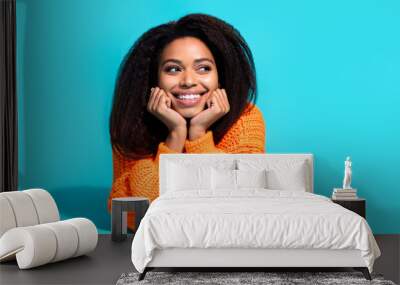 Photo of attractive young woman lying floor look empty space dressed stylish knitted orange clothes isolated on blue color background Wall mural