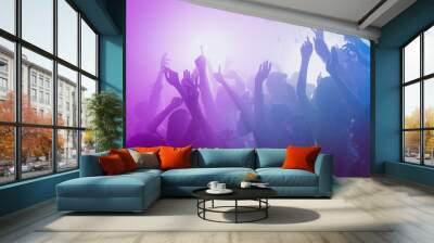 Photo of big company many people funny raise arms dance floor neon bright pink spotlight modern club indoors Wall mural