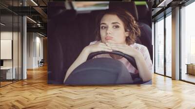 Photo of bored unhappy cute young woman lady driver sleepy sit put head hands steering wheel alone car drive home traffic jam bad news upset expression wear beige t-shirt inside auto salon Wall mural