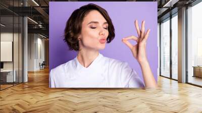 Photo of charming happy young woman make gesture chef kiss tasty meal isolated on violet color background Wall mural