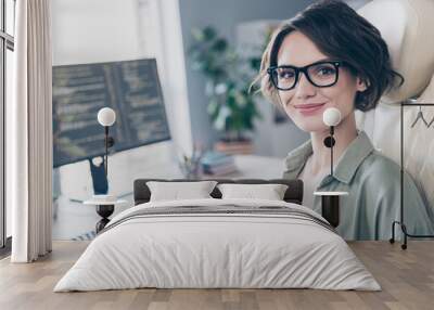 Photo of charming intelligent lady sitting chair near desktop monitor look camera daylight office Wall mural