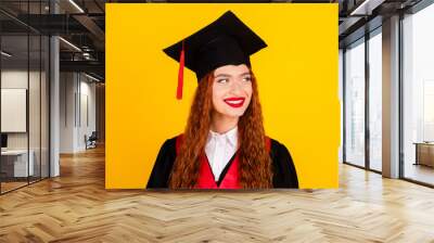 Photo of charming lovely smart girl graduate wear black mantle college education empty space isolated on yellow color background Wall mural