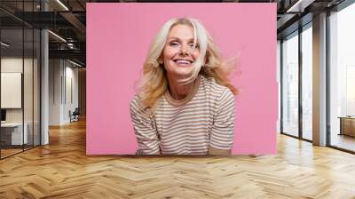 Photo of cheerful adorable retired lady dressed stylish clothes laughing bright white teeth smile isolated on pink color background Wall mural