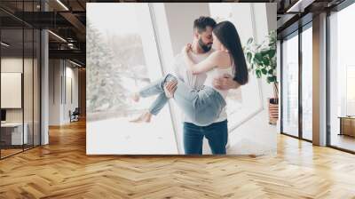 Photo of cheerful cute young couple enjoy weekend couple husband hold wife tenderness buy new apartment indoors inside house home Wall mural