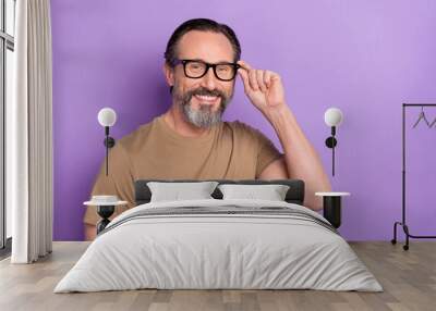 Photo of cheerful positive man wearing spectacles visit oculist check eyesight isolated on violet color background Wall mural