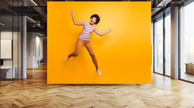 Photo of cheerful positive pretty cute nice charming girlfriend wearing orange pants trousers striped t-shirt with astonishment on face isolated vibrant color background Wall mural