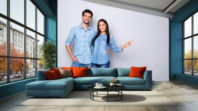 Photo of cheerful trendy charming brown haired nice cute couple of two people pointing at emptiness away wearing jeans denim jackets isolated over grey color white background Wall mural