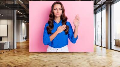 Photo of confident adorable lady wear blue stylish clothes showing arm promise love care appreciate isolated on pink color background Wall mural