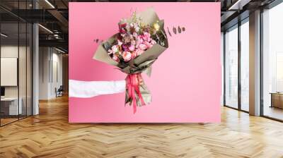 Photo of cropped man arm hold big bright decorated bunch giving girlfriend valentine day romance gift present bouquet composition isolated pink color background Wall mural